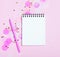 Empty note pad on pink festive background with confetti and sparkles.