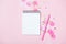 Empty note pad on pink festive background with confetti and sparkles