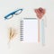 Empty notebook with eyeglasses, a pen and wheat autumn template with colorful leaves, office desk