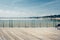 Empty ocean beach boardwalk pier at hot summer day against blue sky