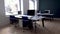 empty office with no employees. room with workplace and blue chairs, computers on white table.