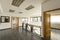 Empty offices with gray stoneware floors, metal railing, wood