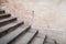 Empty old concrete stairway near stone wall