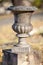 Empty old concrete or stone urn on a small plinth