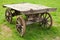 Empty old rural wooden wagon stands on grass