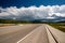 Empty open highway and stormy clouds in Wyoming