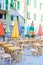 Empty openair cafe with colorful tables at italian old village in Cique Terre
