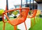 Empty orange chair at top hotel near swimming pool.