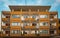Empty orange Italian apartment building with balconies