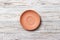 Empty orange matte plate on wooden background