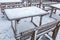An empty outdoor cafe covered in snow