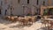 Empty outdoor cafe with tables and chairs in old town of Budva, Montenegro