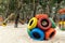 Empty outdoor kids playground at park with handcrafted wheels toy. Nature. Sandy ground. Shape