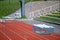 An empty outdoor running track with metal running barriers