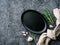 Empty oval cast iron frying pan on dark grey concrete background