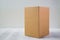 Empty Package brown cardboard box or tray on bright wooden table