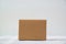 Empty Package brown cardboard box or tray on bright wooden table