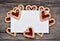 Empty paper with many heart cookies on rustic table