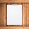 Empty paper sheet stick on wood background.