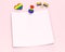 Empty paper square with copy space for your text pinned with rainbow colored pin and some gay pride objects around it. Isolated on