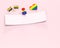 Empty paper strip with copy space for your text pinned with rainbow colored pin and some gay pride objects around. Isolated on