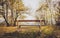 Empty park bench in mountain forest with idyllic golden view.