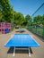 Empty park with blue ping pong table or tennis tables