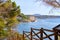 Empty pathway fenced with wooden railings lead to Benissa beach. Spain