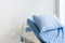 Empty patient`s bed scene with white wooden paint background in natural light scene / hospital and insurance concept / ward room