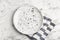 Empty patterned plate and napkin on marble table, flat lay