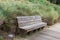 An empty peaceful bench with tall grass behind it with no one on it at the Wright family park in Bluffton, South