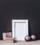 Empty photo frame on brown wall with pink christmas decoration. Styled winter holiday image. Elegant and classy christmas home