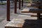 empty picknick tables lined up under a pavilion