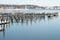 Empty piers on icy river on sunny day after blizzard