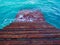 Empty Piers. Wooden stairway going into the sea with small waves and turquoise water.