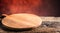 Empty pizza round board old wooden table and colour blurred bac