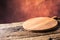 Empty pizza round board old wooden table and colour blurred bac