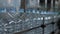 Empty plastic bottles with a volume of 5 liters move along the conveyor in the workshop of the mineral water bottling plant. Produ