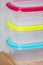 Empty plastic food containers with colorful lids