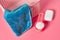 Empty plastic square basket for washing with blue soft towel near antibacterial soap and measuring spoon full of powder