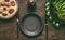 Empty plate with cutlery and low carb dieting meal with meat balls, blanched broccoli in cooking pan and measure tape on wooden