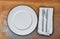 Empty plate with cutlery on rusty steel background