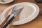 Empty plate with Fork and Knife and breadcrumbs