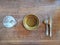 an empty plate and a glass of water on a wooden table. waiting for lunch or dinner