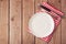 Empty plate with knife and fork on wooden rustic table. View from above.