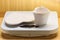 Empty plate saucer and mug cup on weighing scale.