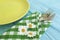 Empty plate of a towel rustic summer on a blue wooden background daisy flower fork, knife