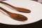 Empty plate with wooden folk and spoon.