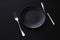 Empty plates and silverware on black background, premium tableware for holiday dinner, minimalistic design and diet