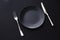 Empty plates and silverware on black background, premium tableware for holiday dinner, minimalistic design and diet